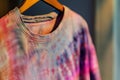 closeup of a tiedye tshirt on a hanger