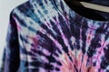 closeup of a tiedye tshirt on a hanger