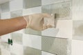 Closeup of tiler hand rubbing tile, Installing and grouting decorative finishes in environments with an high aesthetic value. Two- Royalty Free Stock Photo