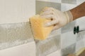 Closeup of tiler hand rubbing tile, Installing and grouting decorative finishes in environments with an high aesthetic value. Two-