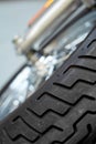 Closeup tilted view of a motorbike tire. Tires designed for custom modern sports bike. Suspension on classic motorcycle