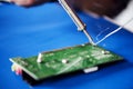 Closeup of tin soldering with electronics circuit board Royalty Free Stock Photo