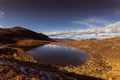 Closeup of tiny mountain lake with Austrian alps background Royalty Free Stock Photo