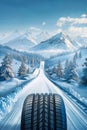 Closeup of a tire on a snowy mountain road. Advertising image of winter tires, space for copy Royalty Free Stock Photo