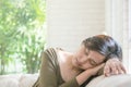 Closeup tired woman sleep at the sofa in room textured background