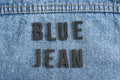Closeup to a BLUE JEAN lettering black word over a Blue jean texture
