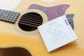 Closeup to D`Addario XS series acoustic strings pakage on the acoustic guitar