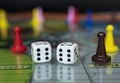 Closeup to a double six old white dices with color pawns over board game Royalty Free Stock Photo