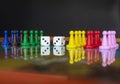 Closeup to a double three white dices with color pawns over a board game Royalty Free Stock Photo