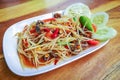 Closeup to Famous Thai food, papaya salad or SOM TAM or Somtum. in white plate. Royalty Free Stock Photo