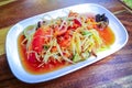 Closeup to Famous Thai food, papaya salad or SOM TAM or Somtum. in white plate. Royalty Free Stock Photo