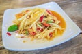 Closeup to Famous Thai food, papaya salad or SOM TAM or Somtum. in white plate. Royalty Free Stock Photo