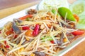 Closeup to Famous Thai food, papaya salad or SOM TAM or Somtum. in white plate. Royalty Free Stock Photo