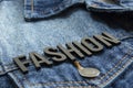 Closeup to a fashion lettering black word over a gradient Blue jean jacket