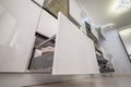 Closeup to furniture details of modern trendy white kitchen