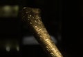 Closeup to a golden graven trumpet of pre columbus ancient cultures