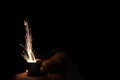 Closeup to hand igniting fire lighters with black background Royalty Free Stock Photo