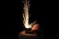 Closeup to hand igniting fire lighters with black background Royalty Free Stock Photo