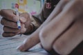 Closeup to hand of student holding pen and taking exam in classroom with stress for education test. Royalty Free Stock Photo