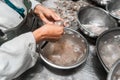 Closeup to the hands of an unrecognizable Nicaraguan female worker cleaning farmed shrimp at a processing plant