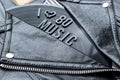 Closeup to a I hearth love 80 music lettering art over a black leather biker jacket with LP vinyl disc