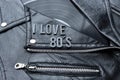 Closeup to a I love 80ÃÂ´s lettering art over a black leather biker jacket with LP vinyl disc