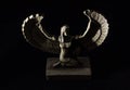 Closeup to a Isis. female old winged egyptian god mini figurine iluminated with white lights Royalty Free Stock Photo