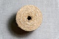 Isolated roll of jute twine over natural linen texture background. Hank of twine closeup. Royalty Free Stock Photo