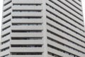 Closeup to an old white building corner with dark rectangle windows form