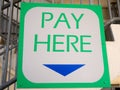 Closeup to a Pay Here sign Royalty Free Stock Photo
