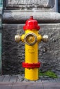 A closeup to a red and yellow fire hydrant Royalty Free Stock Photo