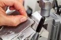 Closeup to the scientist hands working on a rotary microtome to obtain sections from a paraffin-embedded specimen