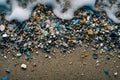 Closeup to sea ocean beach sand with micro plastics. Top view. Environment, pollution, plastic waste concept Royalty Free Stock Photo