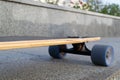 Closeup to skateboard trucks and wheels on the rough asphalt road Royalty Free Stock Photo