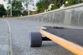 Closeup to skateboard trucks and wheels on the rough asphalt road Royalty Free Stock Photo