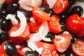 Closeup of tomato, onions and black olives salad washed and cut Royalty Free Stock Photo