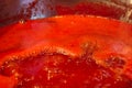 Closeup of tomato sauce boiling and reducing down Royalty Free Stock Photo