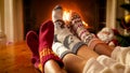 Closeup toned image of family in knitted socks warming by the fireside on Christmas eve Royalty Free Stock Photo