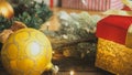 Closeup toned photo of golden bauble and Christmas gifts in boxes. Perfect background for winter holidays Royalty Free Stock Photo