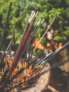 Closeup toned photo of smoke from the burning incenses at buddhist temple garden Royalty Free Stock Photo