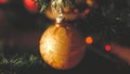 Closeup toned retro photo of golden shiny bauble hanging on Christmas tree Royalty Free Stock Photo