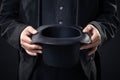 Closeup of top hat in magician hands isolated on dark Royalty Free Stock Photo