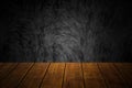 Closeup top old wood table with dark concrete wall loft style background Royalty Free Stock Photo