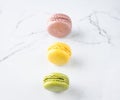Row of bright colored macaroons on marble background