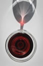 Closeup top view of a glass of red wine with shadows and reflections Royalty Free Stock Photo