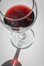 Closeup top view of a glass of red wine with shadows and reflections Royalty Free Stock Photo