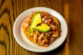 Closeup top view of a Mexican Tostada with toasted tortilla and avocado on the top