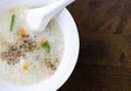 Closeup top view mush or boiled rice in white bowl, morning breakfast Royalty Free Stock Photo