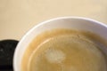 Closeup top view of one-off cup of coffee with foam Royalty Free Stock Photo