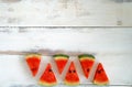 Closeup top view shot tropical organic juicy healthy tasty fruit red triangle sliced watermelon pieces with green peel black seeds Royalty Free Stock Photo